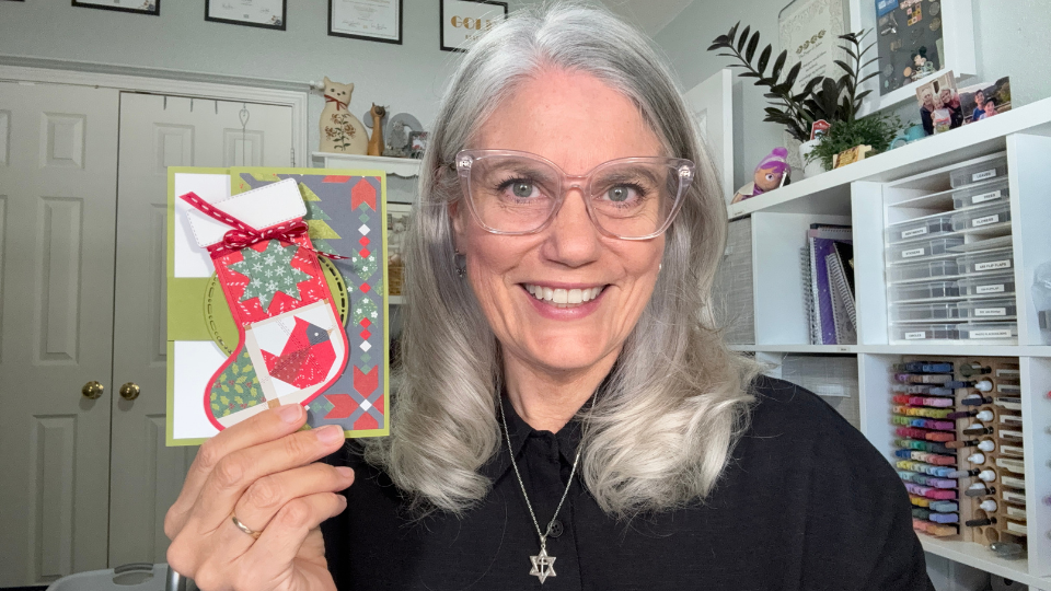 Woman holding a handmade hinge fun fold Christmas card