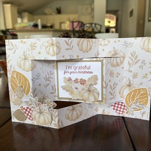 Trifold shutter card standing open showing the folded shutter panel design