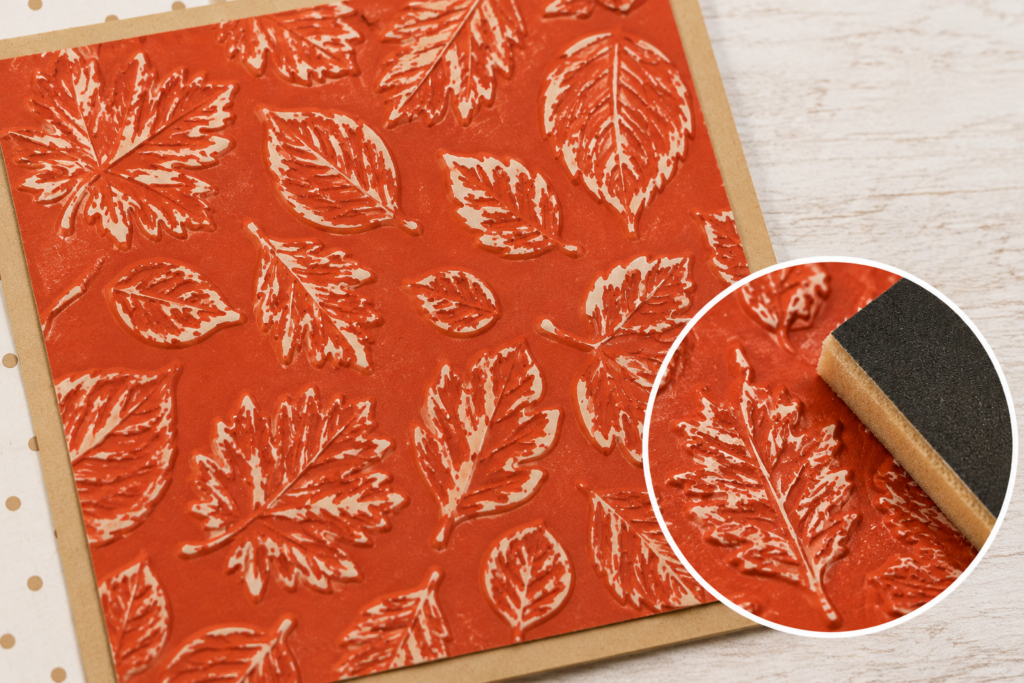 Close-up of embossed Two-Tone Cardstock after sanding, revealing the white core to highlight the raised fall leaf design.